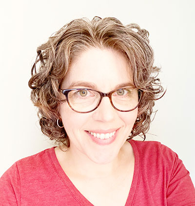 Portrait of Christine Bagwell in a red shirt with a white background