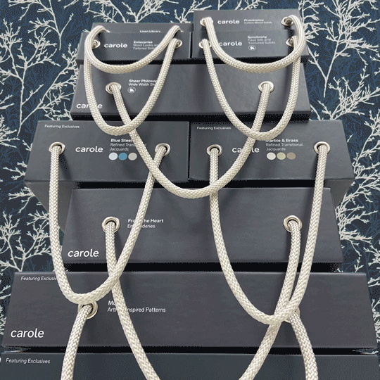 An animation featuring static image of a stack of fabric sample books with a background of continually changing fabric patterns.